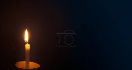 Photo for Burning candle on a dark background. Copy space for text. - Royalty Free Image