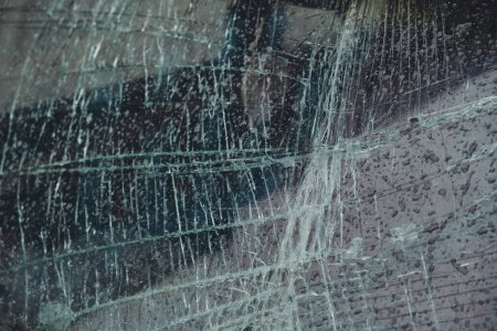 Foto de Car Glass Cracks. Many cracks on broken windshield. Windshield of the car cracked from the impact with many chips. - Imagen libre de derechos