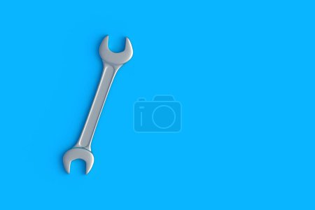 Spanner on blue background. Metal wrench in workshop. Repair and maintenance tool. Top view. Copy space. 3d render