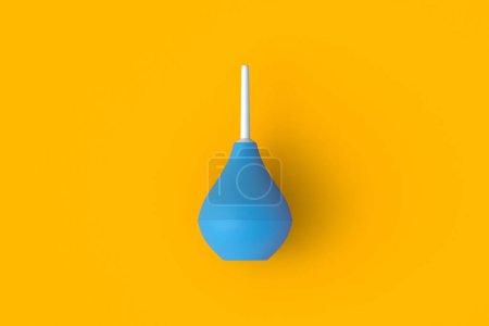 Photo for Enema on orange background. Rubber douching bag. Pear shaped syringe bulb. Medical clyster. Nasal aspirator. Laboratory tool. Constipation treatment. Top view. 3d render - Royalty Free Image