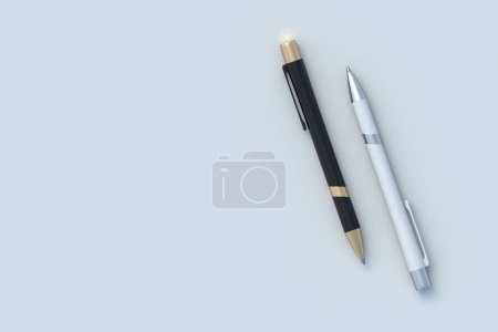 Photo for Two pens on gray background. Ink ballpoint. School accessories. Office supplies. Stationery for education. Top view. Copy space. 3d render - Royalty Free Image