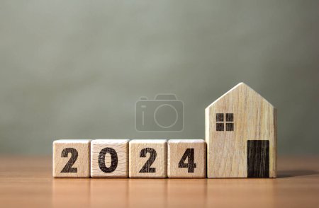 Wooden block number 2024 with wooden house model New Year's Real Estate Investment Ideas