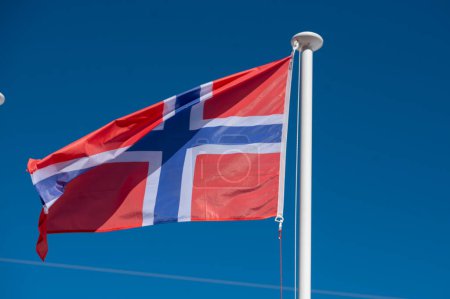 Waving flag of Norway with sunny day.