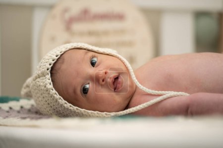 Photo for Baby with two months of life in his crib with a wool cap. - Royalty Free Image
