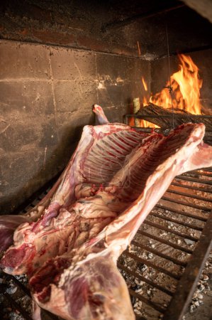 Photo for Grilled lamb made with firewood in the countryside of Uruguay. - Royalty Free Image