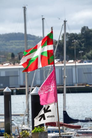 Foto de Pasaia, España: 2024 Marzo 24: Ikurria, la bandera del País Vasco dañada por el tiempo en la ciudad pesquera y turística de Pasaia en la provincia de Guipúzcoa en marzo 2024. - Imagen libre de derechos