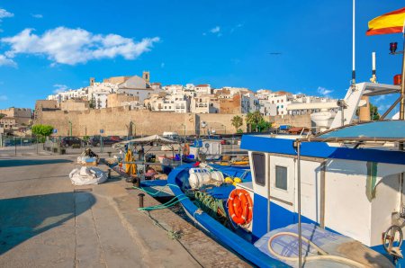 Photo for Wharf with fishing boat moored in local port and view of old town. Peniscola, Spain - Royalty Free Image