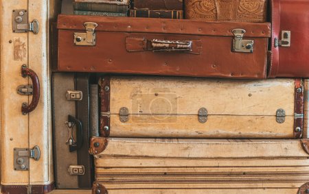 Old suitcases background. Vintage classic retro leather suitcases and travel bags. Retro style, travel concept. High quality photo