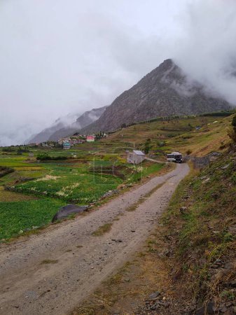 Photo for Lahaul and Spiti, Himachal Pradesh, India - 12 September 2021 : Village in Mountains covered by clouds. - Royalty Free Image