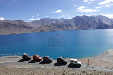 Photo for Ladakh, India - August 24th, 2022: SUV car at Pangong Lake, world's highest saltwater lake, offroading in mountains of Ladakh. - Royalty Free Image