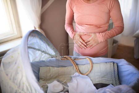Foto de Primer plano de una mujer embarazada que se prepara para el bebé. - Imagen libre de derechos