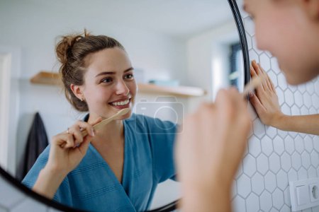 Foto de Mujer joven cepillándose los dientes, concepto de rutina matutina. - Imagen libre de derechos