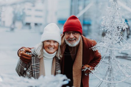 Photo for Senior couple walking in a winter city center. - Royalty Free Image