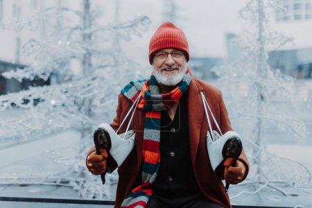 Photo for Portrait of happy senior man in winter at an outdoor ice skating rink. - Royalty Free Image