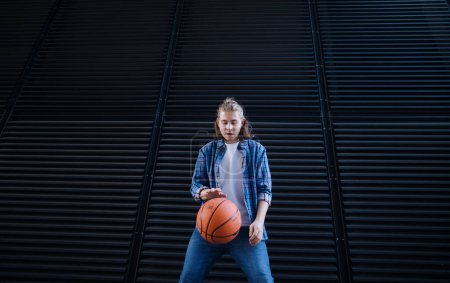 Photo for Young man dribbling with a basketball ball,outdoor in city. Youth culture. - Royalty Free Image