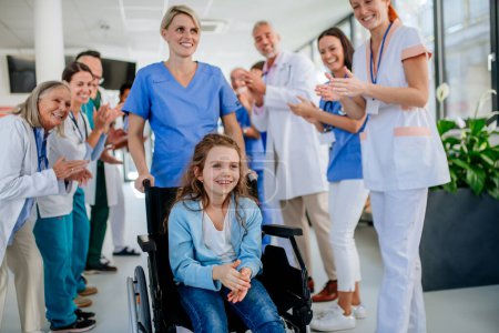 Photo for Medical staff clapping to patient who recovered from a serious illness. - Royalty Free Image