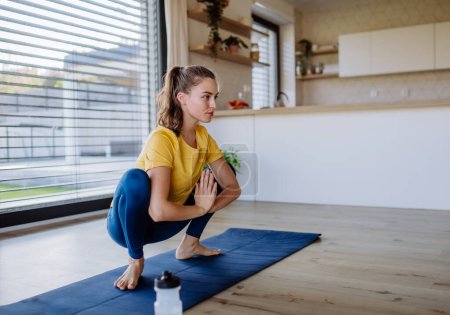 Young woman doing exercises at home.