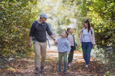 Photo for Happy family with kids walking in a forest. - Royalty Free Image