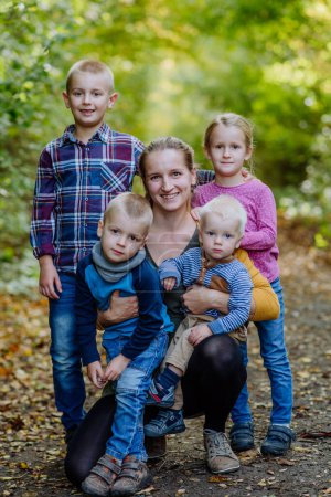 Photo for Portrait of happy mother with her four kids at a forest. - Royalty Free Image
