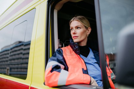 Photo for Portrait of young woman doctor sitting in the ambulance car. - Royalty Free Image