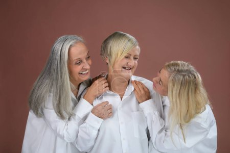 Foto de Portrait of three happy senior friends in a studio. - Imagen libre de derechos