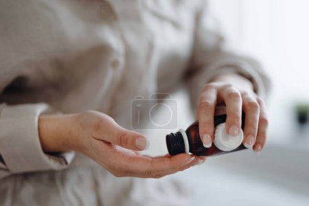 Photo for Close-up of woman with cancer taking the pills, cancer awareness concept. - Royalty Free Image