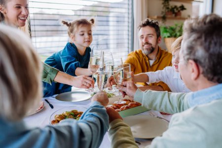 Téléchargez les photos : Happy family toasting before an Easter dinner. - en image libre de droit