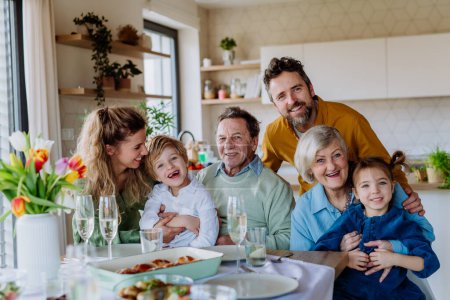 Photo for Portrait of happy multigenerational family during Easter lunch. - Royalty Free Image