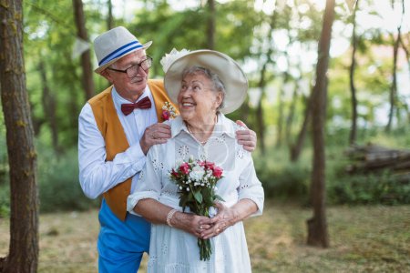 Senior couple having marriage in nature during a summer day.