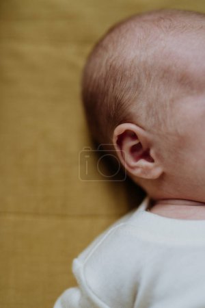 Foto de Close-up of babys head during the sleep in a bed. - Imagen libre de derechos