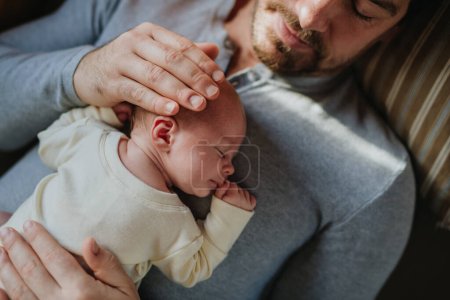 Photo for Close-up of father cuddling his little new born baby. - Royalty Free Image