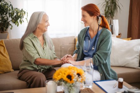 Téléchargez les photos : Portrait of caregiver holding hand to senior client. - en image libre de droit