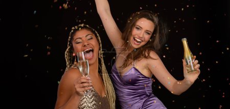 Foto de Portrait of two well-dressed friends celebrating wih glass of wine. - Imagen libre de derechos