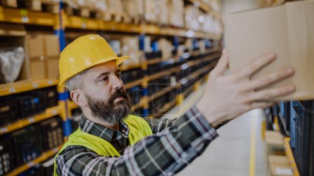 Photo for Warehouse worker checking up stuff in warehouse. - Royalty Free Image