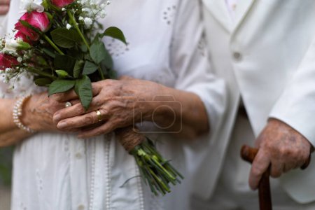 Photo for Close-up of seniors hands with golden wedding rings during their marriage. - Royalty Free Image