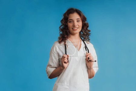 Photo for Portrait of a young curly nurse, studio shoot. - Royalty Free Image