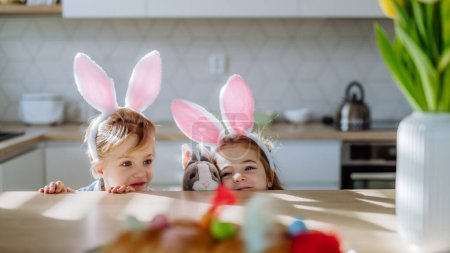 Photo for Little siblings enjoying easter time together in their home. - Royalty Free Image