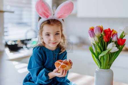 Foto de Little girl holding an easter pastries, celebrating easter and spring. - Imagen libre de derechos