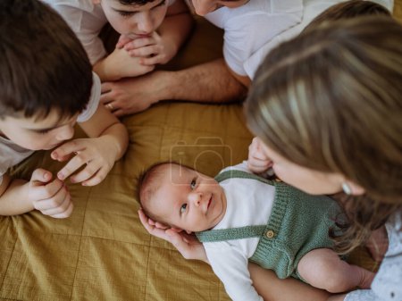 Photo for Big family with four sons enjoying their newborn baby. - Royalty Free Image