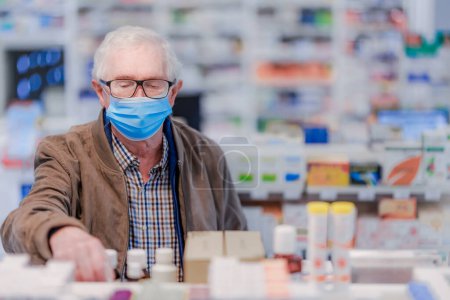 Photo for Senior man choosing medication in a pharmacy store. - Royalty Free Image