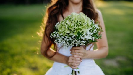 Photo for Close-up of brides bouquet, outdoor in a meadow. - Royalty Free Image