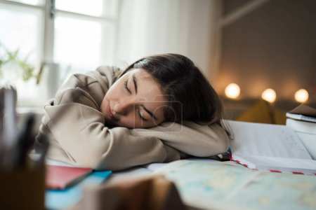 Photo for Teenage girl fall asleep during studying in the room. - Royalty Free Image
