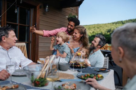 Photo for Multigenerational family having bbq party and taking a selfie. - Royalty Free Image