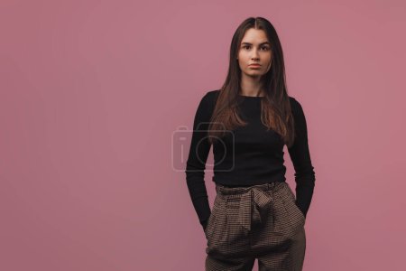 Photo for Portrait of a young woman in studio, pink background. - Royalty Free Image