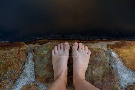Photo for Close up of the feets standing in wooden pier near the lake, summer day, holiday and vacations concept. - Royalty Free Image