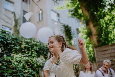 Photo for Little girl having fun at an outdoor wedding party. - Royalty Free Image