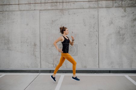 Photo for Young woman jogging in city, healthy lifestyle and sport concept. - Royalty Free Image