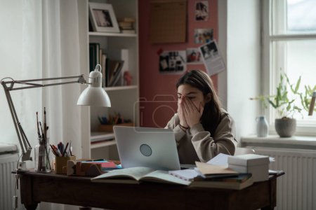 Photo for Young teenage girl studying and doing homework in her room. - Royalty Free Image