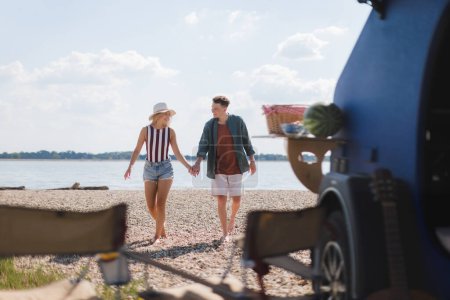 Photo for Young couple in front of van during summer holiday. - Royalty Free Image