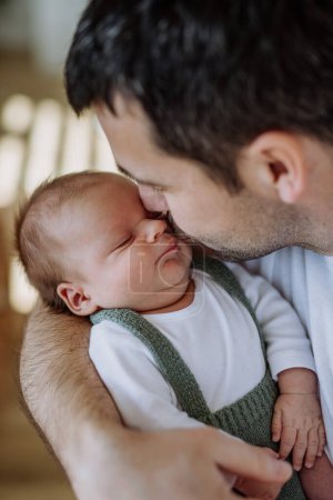 Photo for Close-up of father kissing his little new born baby. - Royalty Free Image